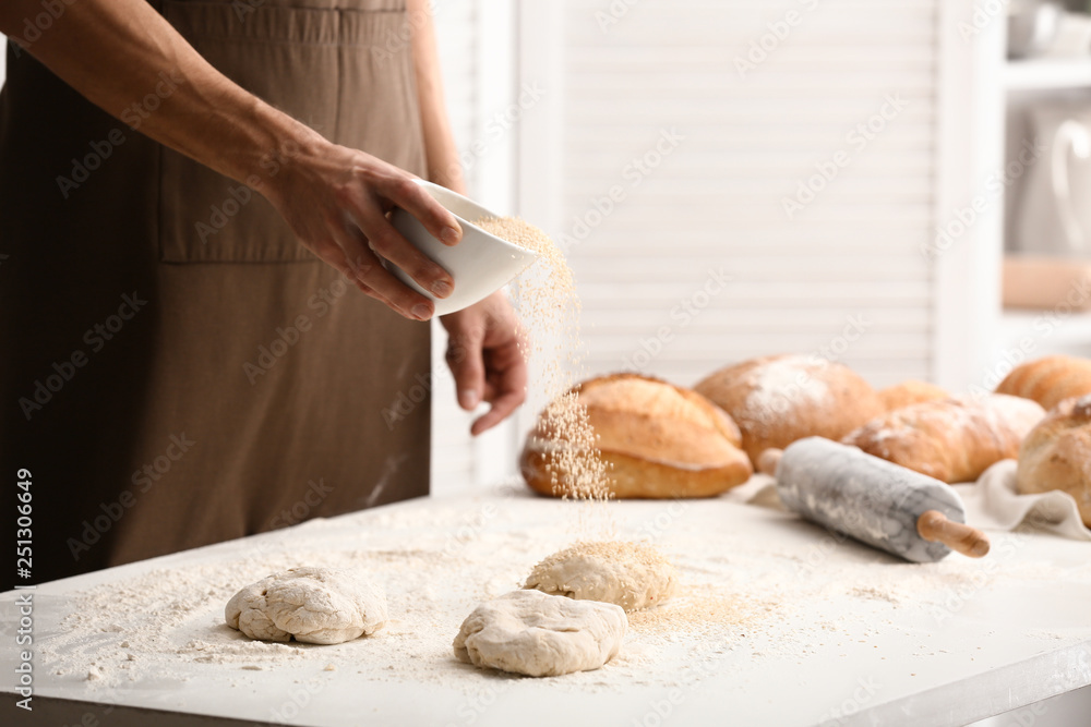 Young man preparing bread in kitchen Young man preparing bread in kitchen