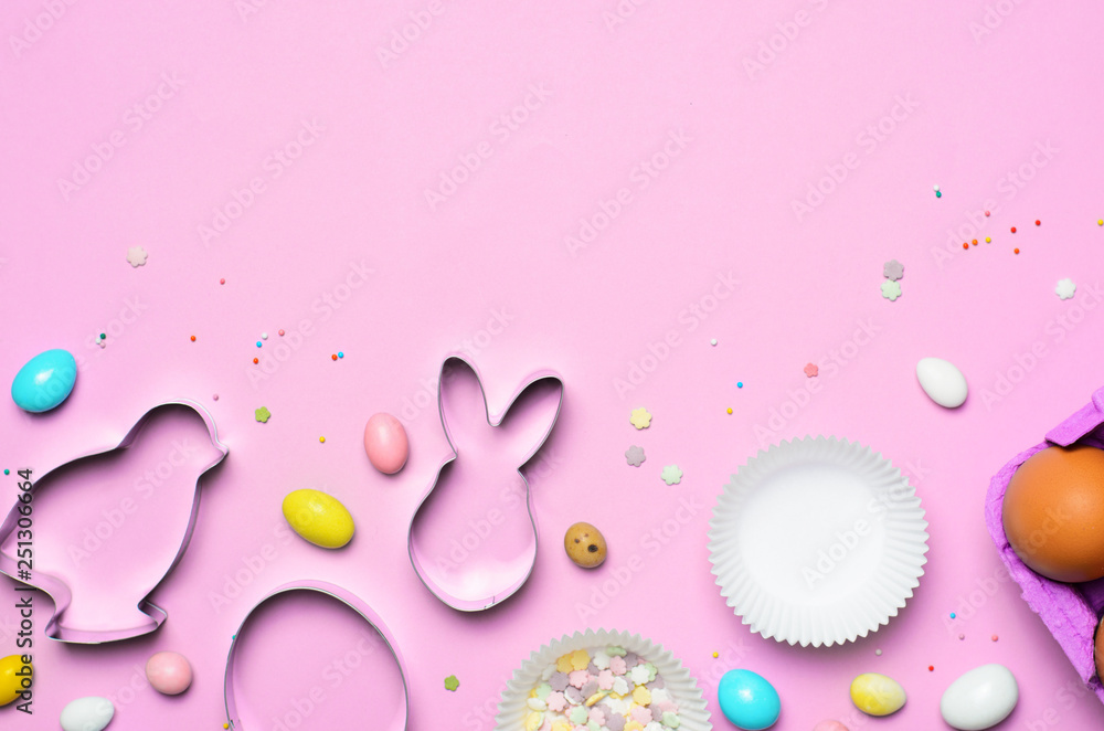 Easter Concept, Cookie Cutters, Eggs, Sugar Sprinkles and Chocolate Eggs on Bright Background Easter Concept, Cookie Cutters, Eggs, Sugar Sprinkles and Chocolate Eggs on Bright Background