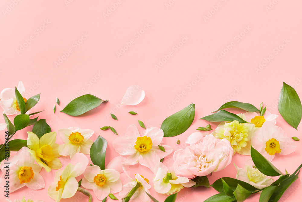 Fototapeta premium Decorative frame from spring flowers on a color background of the year 2019 Living Coral Pantone. Mother's Day. Flat lay.