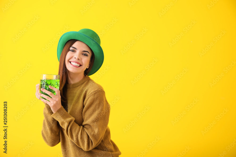 Beautiful young woman in green hat and with mug of beer on color background. St. Patrick's Day celebration Beautiful young woman in green hat and with mug of beer on color background. St. Patrick's Day celebration