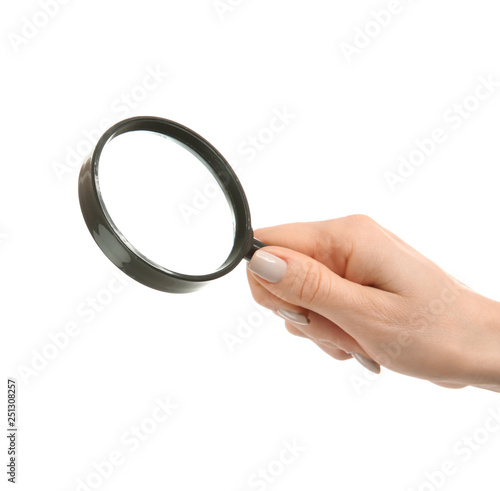 Female hand with magnifier on white background photo