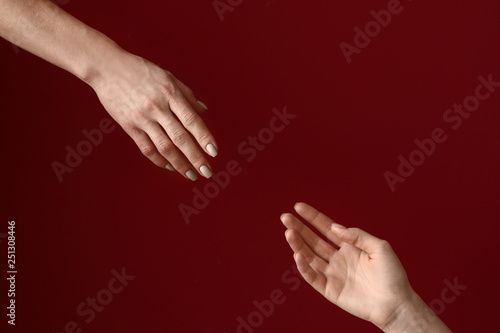 Female hands reaching out to each other on color background. Stop a suicide