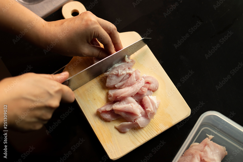 Chef cutting meat.