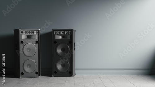 Photos Two modern black audio speakers in interior near the wall