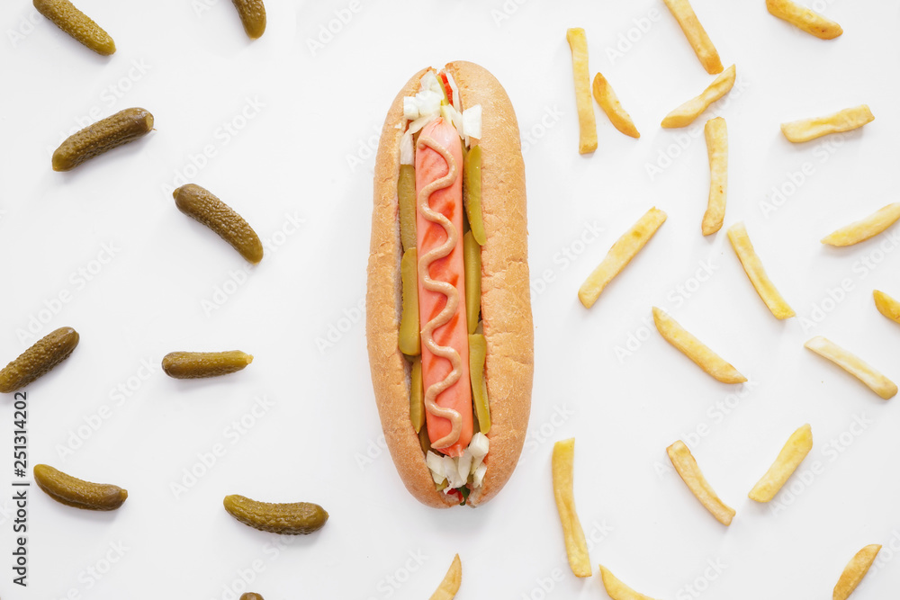 Tasty hot dog, pickled cucumbers and french fries on white background Tasty hot dog, pickled cucumbers and french fries on white background