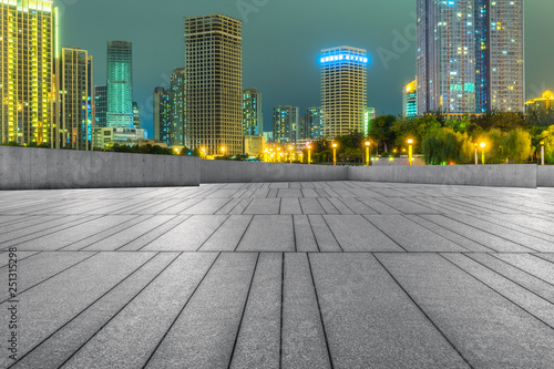 night view of empty brick floor front of modern building