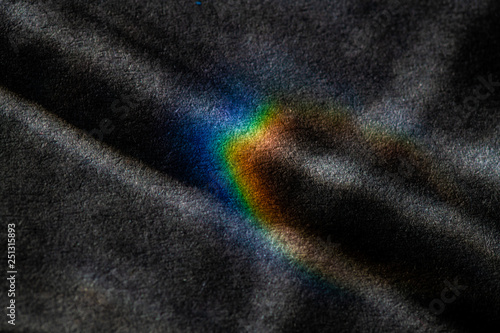 abstract light glow, lens flare, caustics water glas reflections.  light through a prism. black background. 
