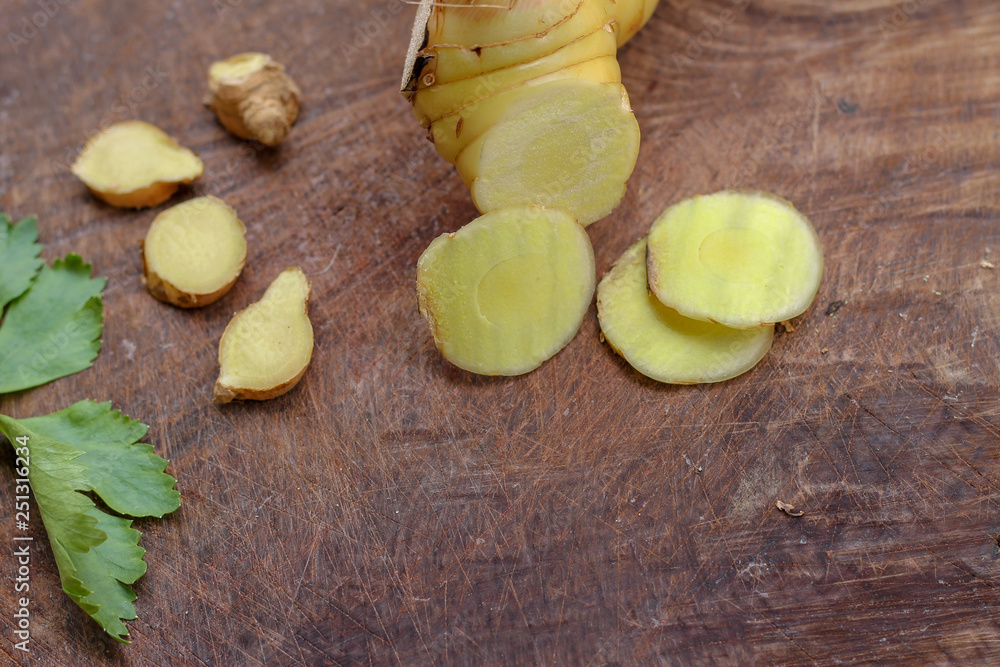 Galangal cut into thin strips with celery leaves. Galangal cut into thin strips with celery leaves.