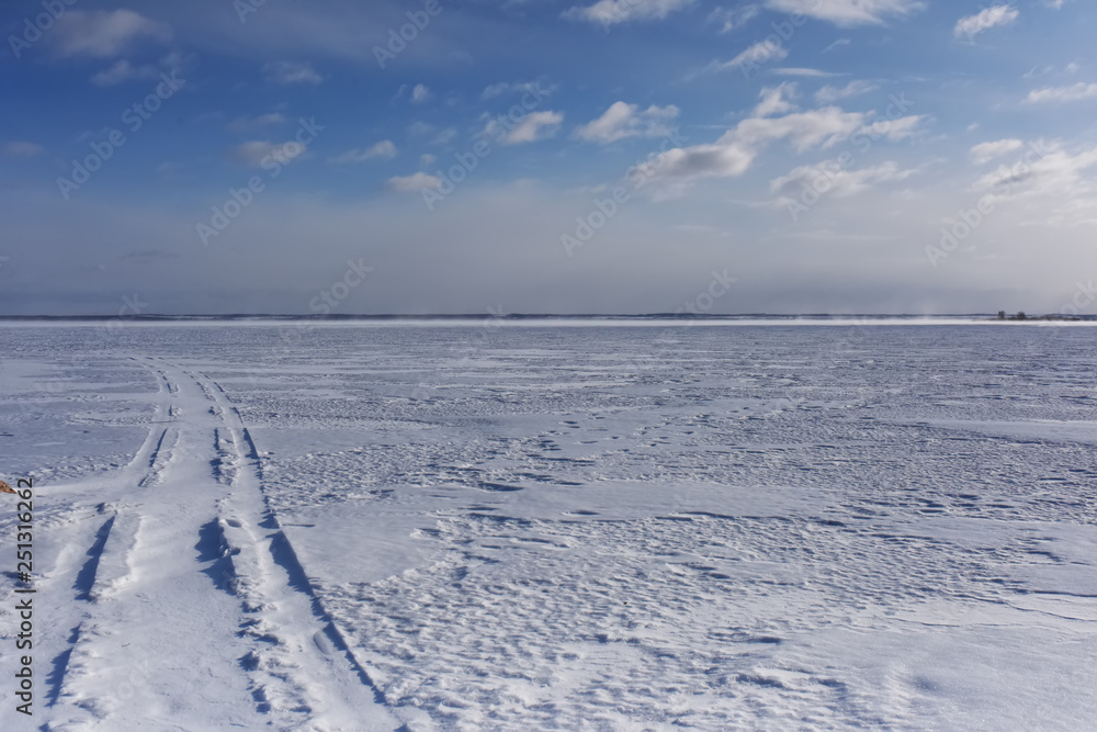 road to the horizon on the ice-covered lake