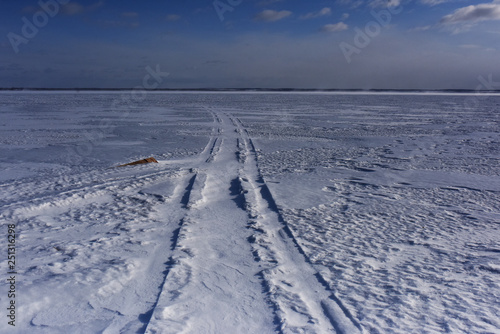 road to the horizon on the ice-covered lake © orlovphoto