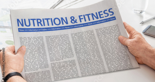 Photography Man reading newspaper with the headline Nutrition and Fitness