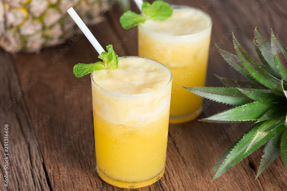 Fototapeta premium Tropical drink, Pineapple smoothie in glass with fresh pineapple.