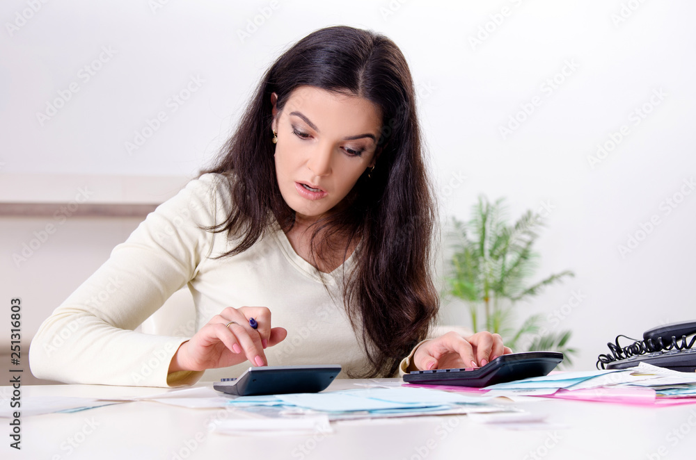 Young woman with receipts in budget planning concept Young woman with receipts in budget planning concept