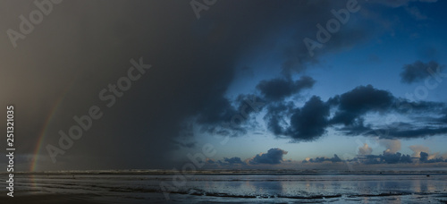 Bilde på lerret Approaching Storm - Rainbow appears in an approaching storm along the ocean