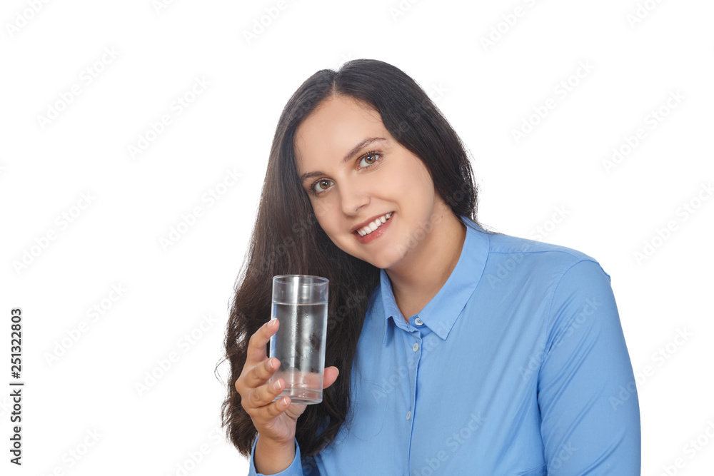 Beautiful girl smiling while holding a glass of water