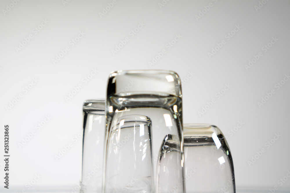 Three different empty shot glasses on white background. Three different empty shot glasses on white background.