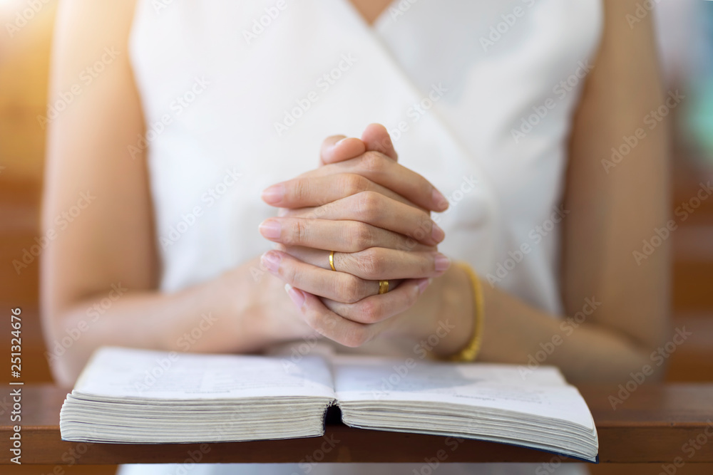Woman hands praying on a holy bible in church for faith concept, Spirituality and Christian religion. Woman hands praying on a holy bible in church for faith concept, Spirituality and Christian religion.