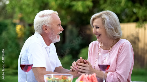 Laughing senior couple having fun during dinner  positive emotions  happiness
