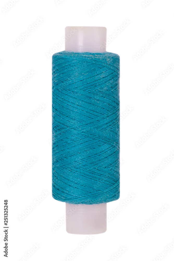 Turquoise sewing thread reel on white isolated background Turquoise sewing thread reel on white isolated background