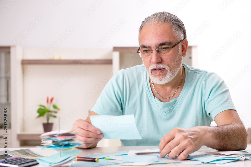 White bearded old man in budget planning concept White bearded old man in budget planning concept