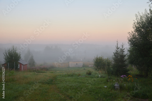 Heavy fog over village in summer, Moscow Region, Russia