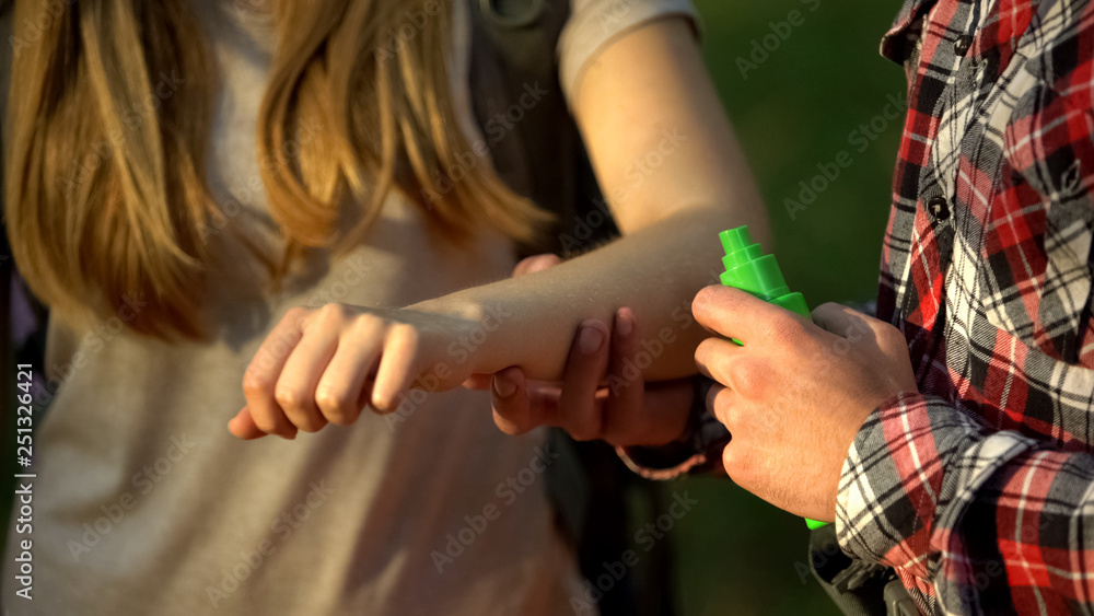 Man applying cooling cream on ladys arm after mosquitoes bite, insect repellent