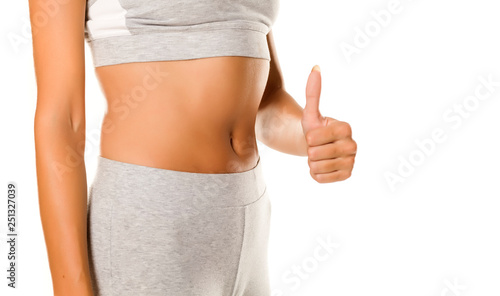 sexy slim female belly and thumbs up on white background