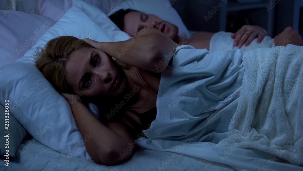 Wife in bed with husband, sleepless because of snoring, nasal septum deviation Wife in bed with husband, sleepless because of snoring, nasal septum deviation