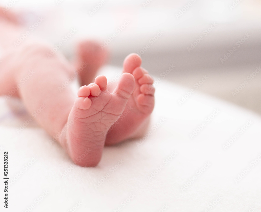 Gentle baby feet. Gentle blurred background of the feet and heels of a newborn Gentle baby feet. Gentle blurred background of the feet and heels of a newborn