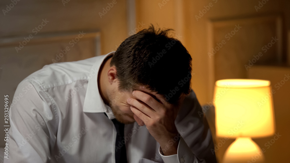 Ill businessman having strong headache, migraine problem, overworking lifestyle Ill businessman having strong headache, migraine problem, overworking lifestyle