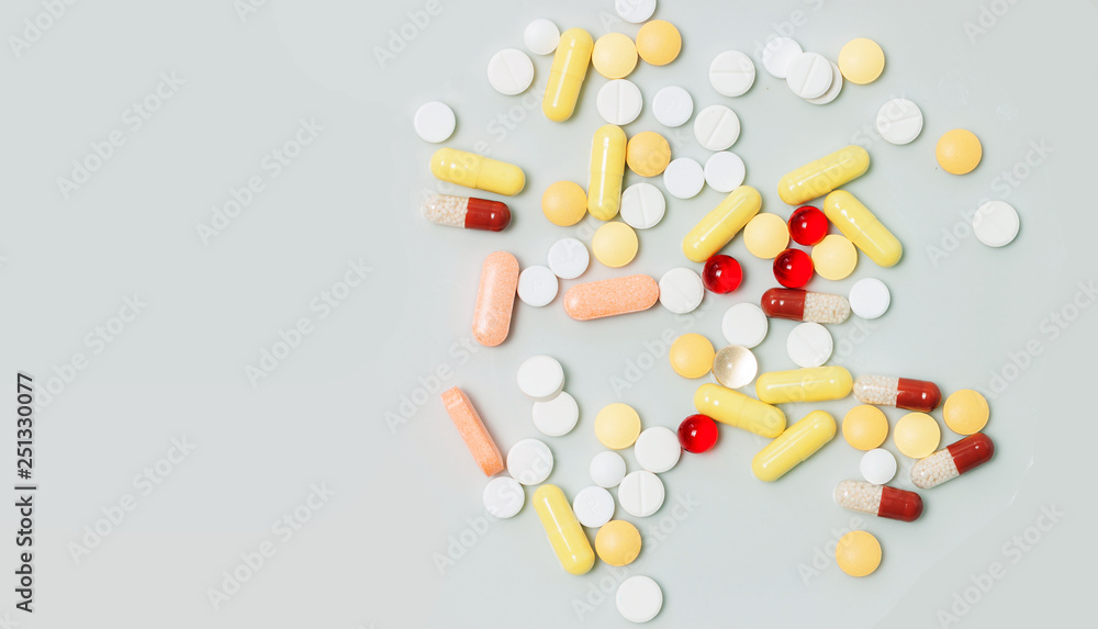 medicine pills, tablets and capsules on wooden spoon medicine pills, tablets and capsules on wooden spoon