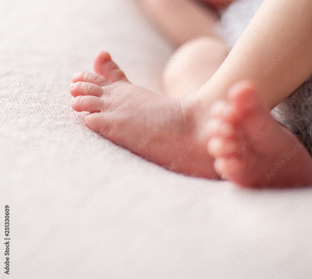 Gentle baby feet. Gentle blurred background of the feet and heels of a newborn Gentle baby feet. Gentle blurred background of the feet and heels of a newborn