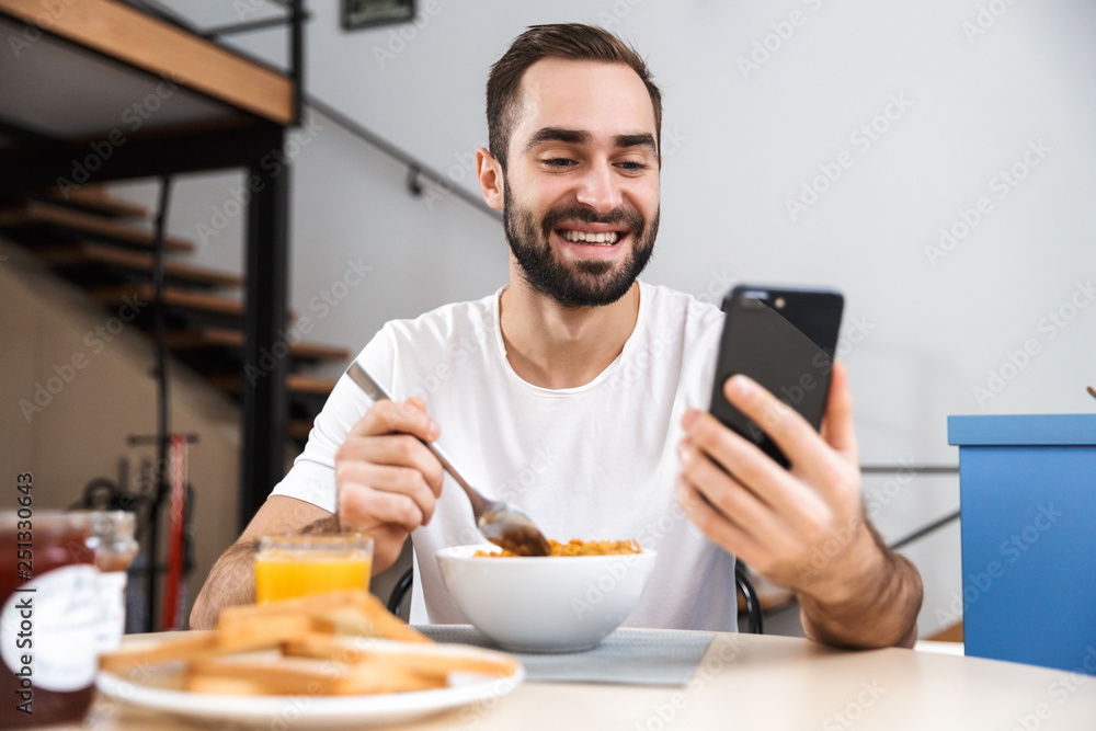 Handsome young man having breakfast Handsome young man having breakfast