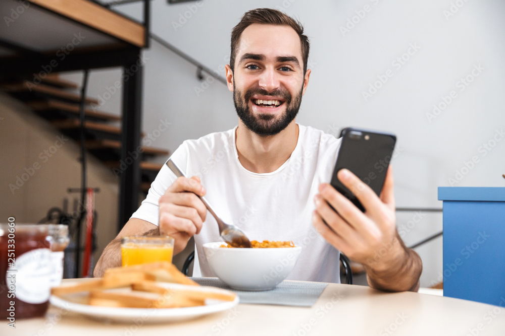 Handsome young man having breakfast Handsome young man having breakfast
