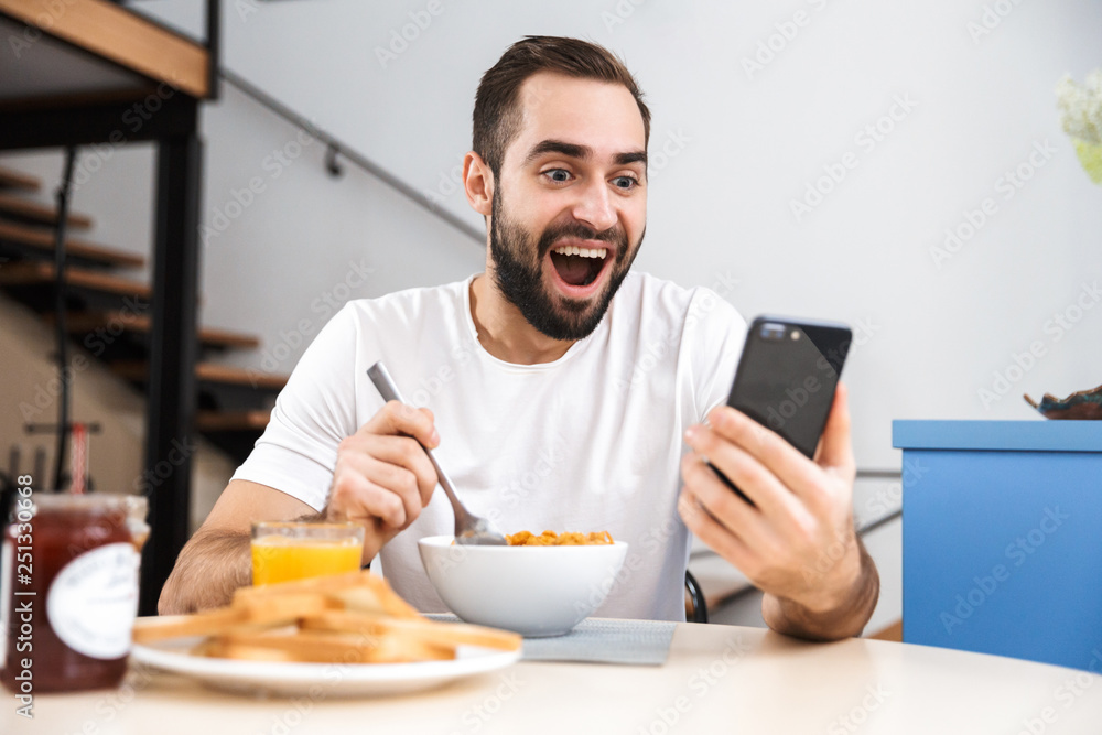 Handsome young man having breakfast Handsome young man having breakfast