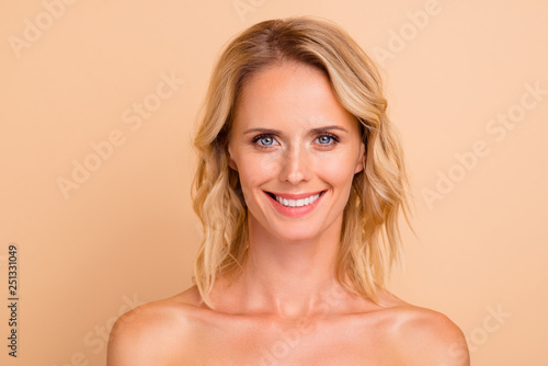 Anti age facial care advertising concept. Close-up portrait of nice attractive cheerful wavy-haired lady with smooth fresh healthy skin isolated over beige pastel background