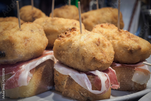 Iberian ham croquette in a pinchos bar in Bilbao, typical tapa in Spain photo