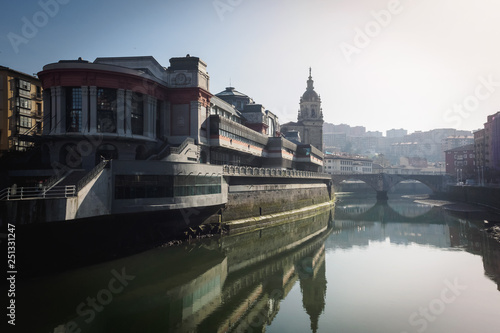 The Ribera market and the church of San Anton of Bilbao seen from the river photo