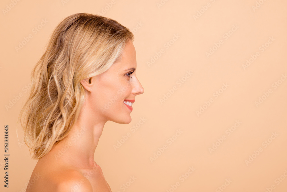 Facial detox ad concept. Profile side view portrait of her she attractive cheerful wavy-haired nude lady with fresh clear clean flawless smooth skin copy empty blank space isolated on beige background Facial detox ad concept. Profile side view portrait of her she attractive cheerful wavy-haired nude lady with fresh clear clean flawless smooth skin copy empty blank space isolated on beige background