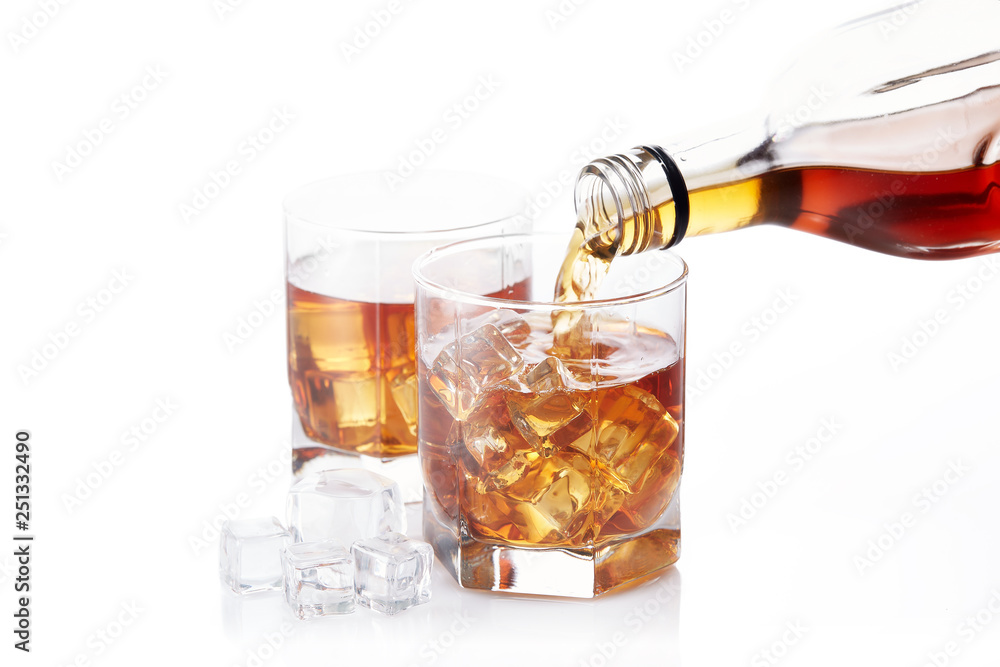 Bottle of whisky and two glasses. Pouring Bottle of whisky and two glasses. Pouring