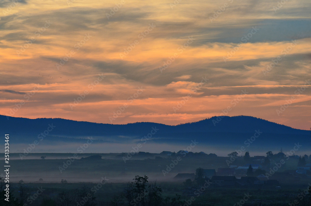 Fototapeta premium Summer evening. Fog appears in the lowlands. It becomes cool and damp. Smells like herbs and berries