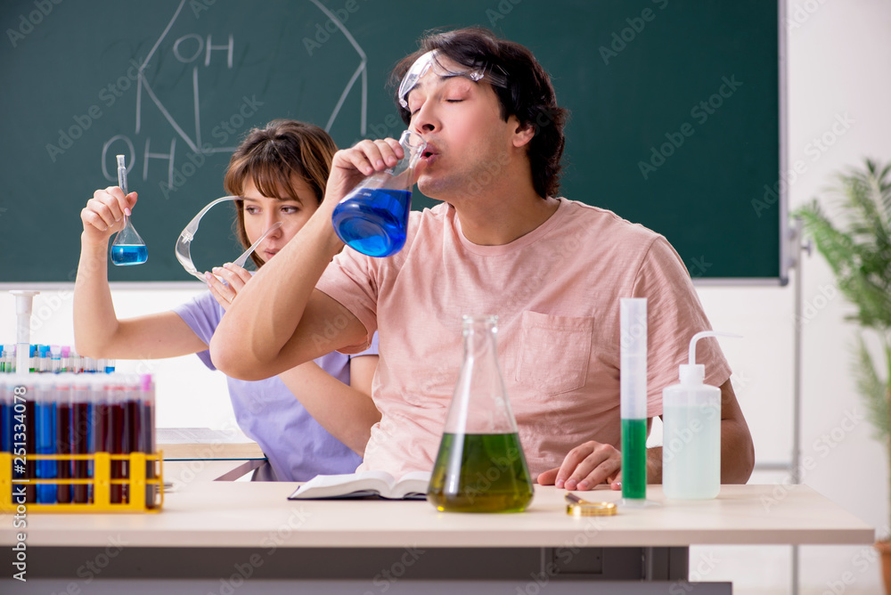 Two chemists students in classroom Two chemists students in classroom