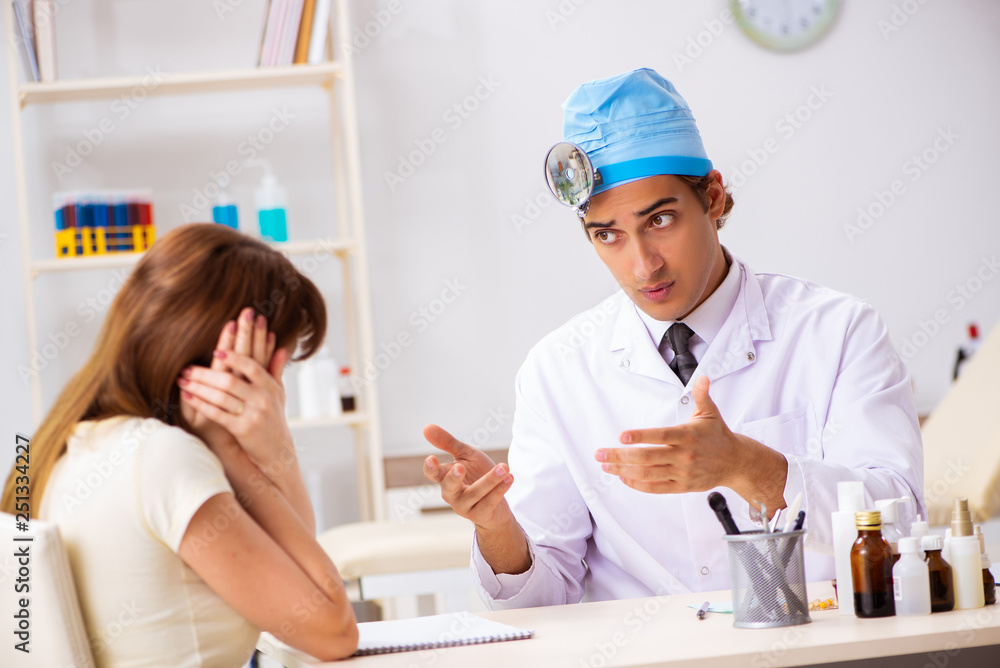 Young woman visting male doctor otolaryngologist Young woman visting male doctor otolaryngologist