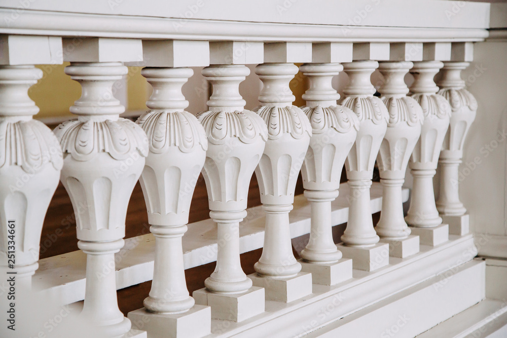 A row of white concrete balusters in the castle. Baroque style.