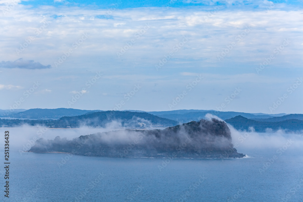 Lion Island covered by low clouds at Broken Bay. Sydney, New South Wales, Australia Lion Island covered by low clouds at Broken Bay. Sydney, New South Wales, Australia
