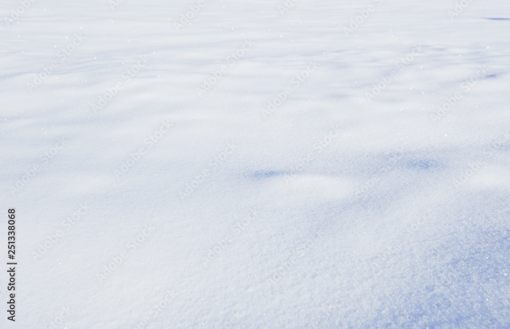 Natural winter background with snow field and drifts in blue tone Natural winter background with snow field and drifts in blue tone