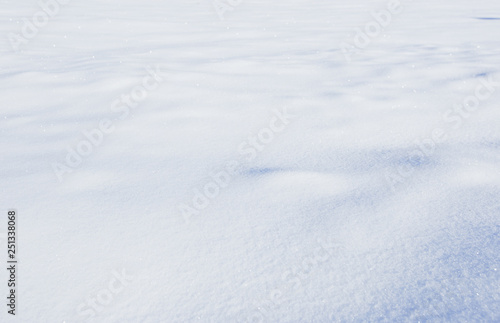 Natural winter background with snow field and drifts in blue tone