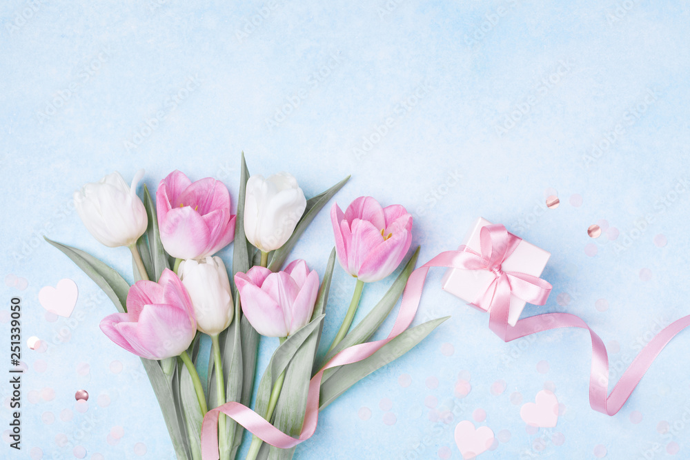 Women Day, Mother day background with gift box and beautiful spring tulip flowers on pastel blue table. Flat lay. - obrazy, fototapety, plakaty 