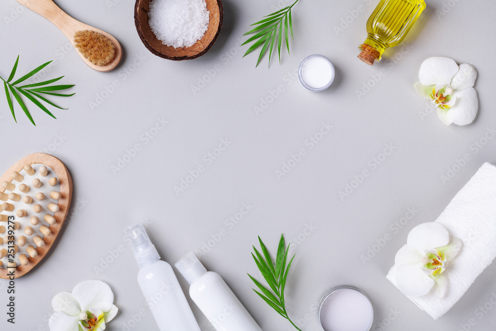 Spa, aromatherapy, beauty and wellness background with massage brush, orchid flowers and products. Top view flat lay. Photo | Adobe Stock