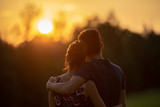 Young couple at sunset, closeup portrait with selective focus